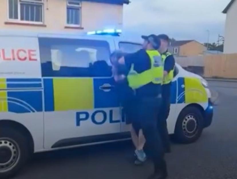 Police officer punching a biker.