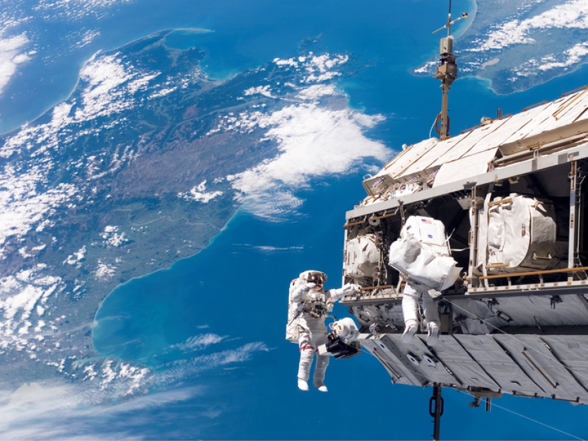 Two astronauts performing a spacewalk.