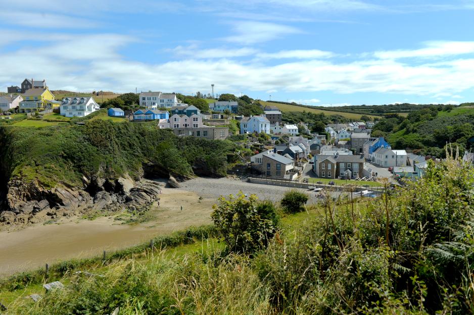 Little Haven, Pembrokeshire, West Wales, overlooking the beach and houses on a cliffside.
