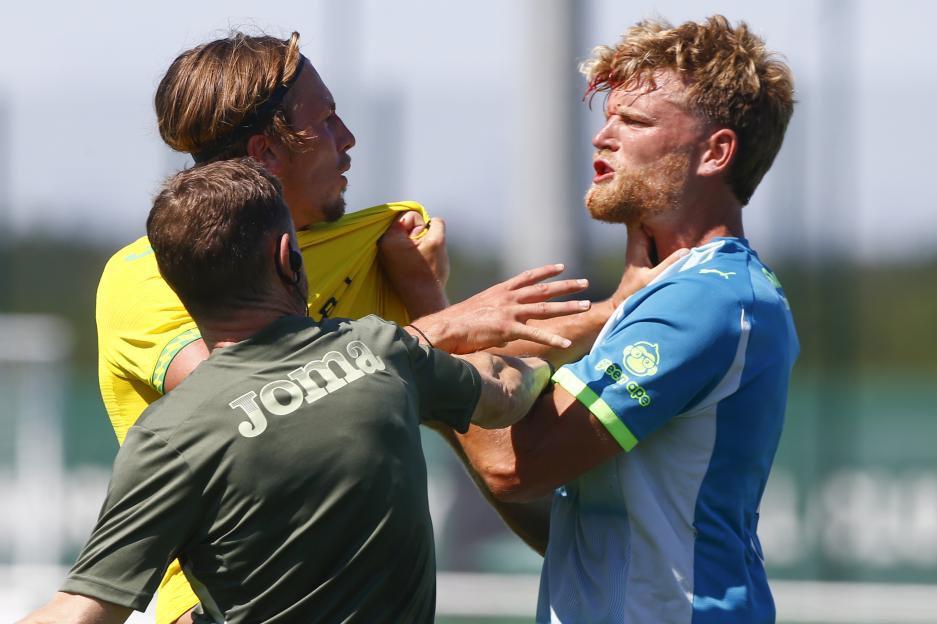 Two soccer players clash after receiving treatment for head injuries.