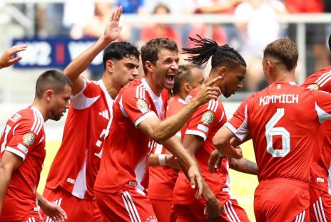 Bayern Munich's Thomas Müller celebrating with teammates.