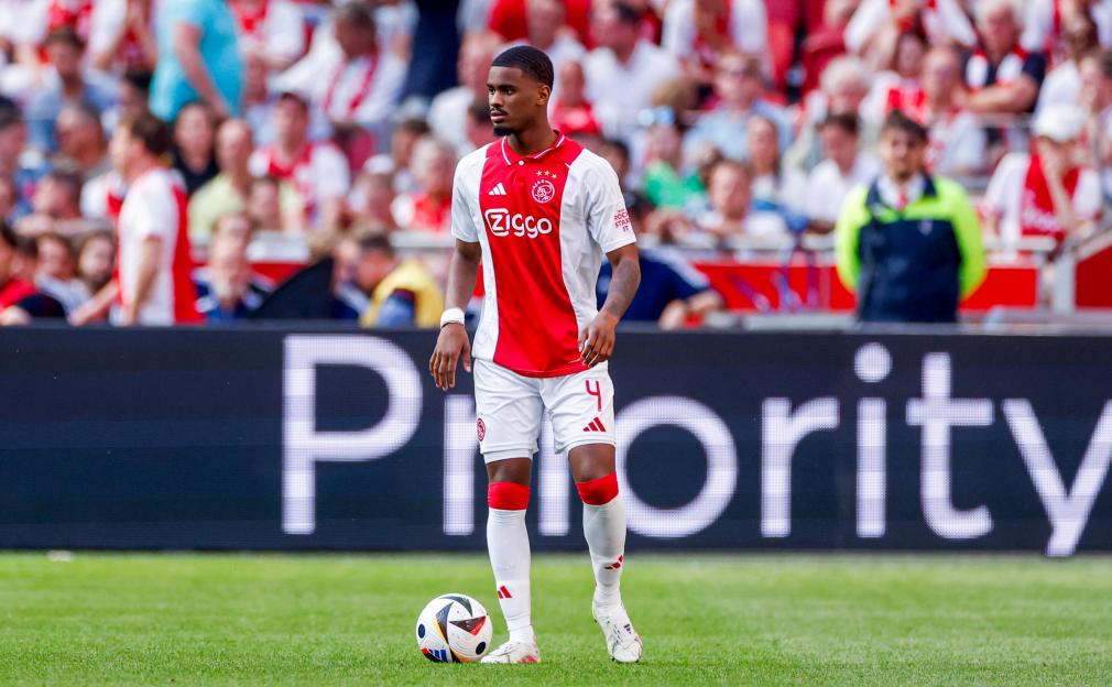 Jorrel Hato of Ajax controlling the soccer ball during a match.