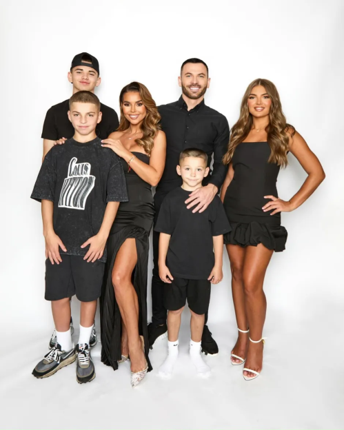 Family portrait of two parents and four children.