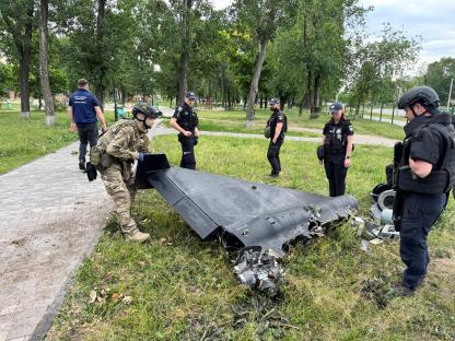 Police bomb squad members inspecting the wreckage of a Russian kamikaze drone in Kharkiv, Ukraine.