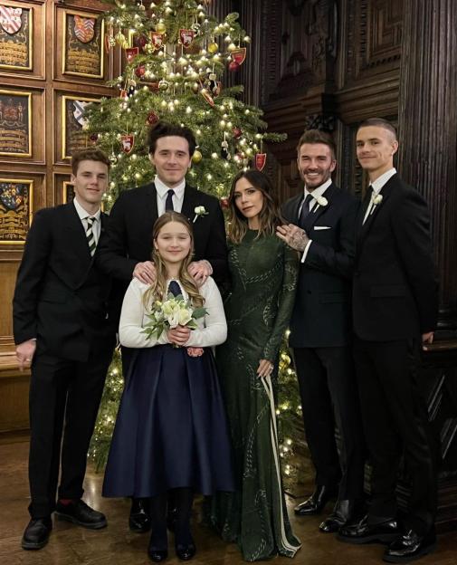 The Beckham family in front of a Christmas tree.