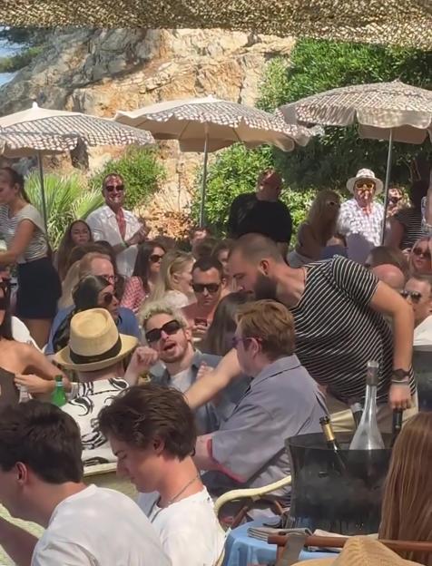 Brooklyn Beckham and Elton John at a party.