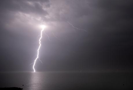 Lightning striking the sea during a storm.