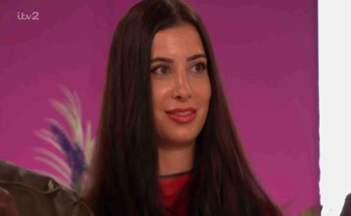 Close-up of a woman with long dark hair.