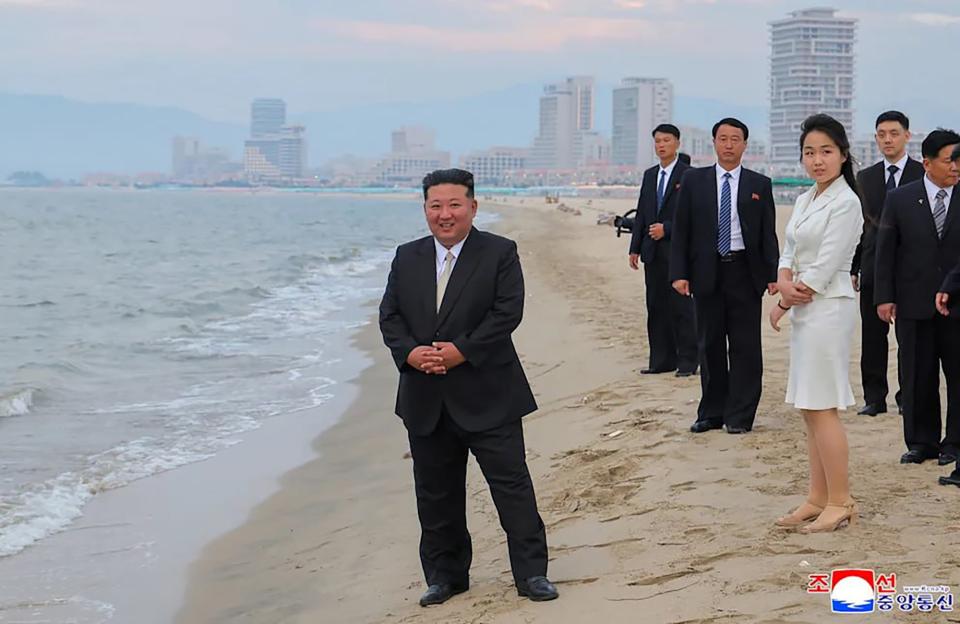 Kim Jong-un on a beach with his entourage.