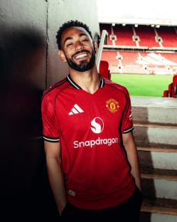 MANCHESTER, ENGLAND - JUNE 12: (EXCLUSIVE COVERAGE) Matheus Cunha of Manchester United poses for a photo after signing his contract with the club at Old Trafford on June 12, 2025 in Manchester, England. (Photo by Manchester United/Manchester United via Getty Images)