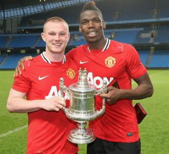 Paul Pogba and Ryan Tunnicliffe of Manchester United Reserves celebrating with the Manchester Senior Cup trophy.