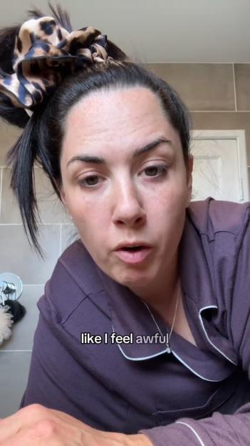 Woman in pajamas describing feeling awful.