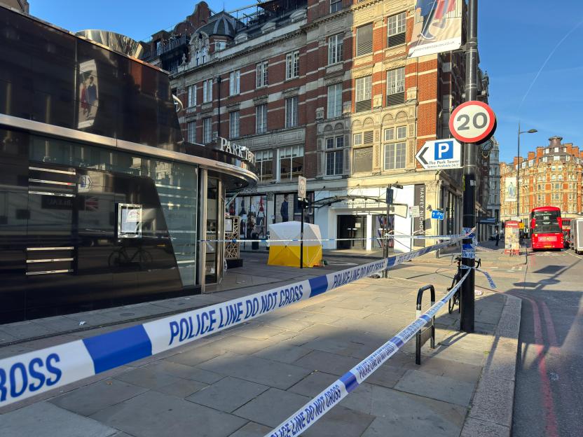 Crime scene cordoned off with police tape near Park Tower Hotel.