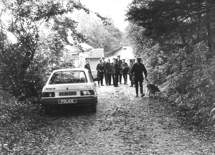 Police and a dog unit investigating a murder.