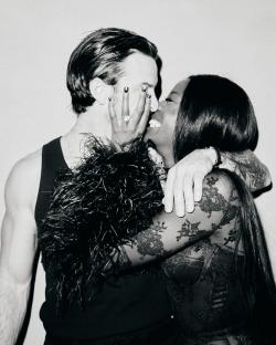 Black and white photo of a couple kissing.
