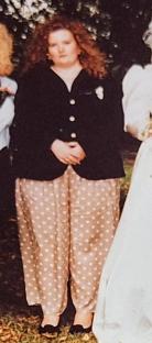 Woman in a black jacket and polka dot pants.