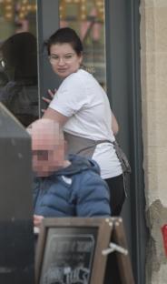 Maternity nurse Emily Waters outside a building.