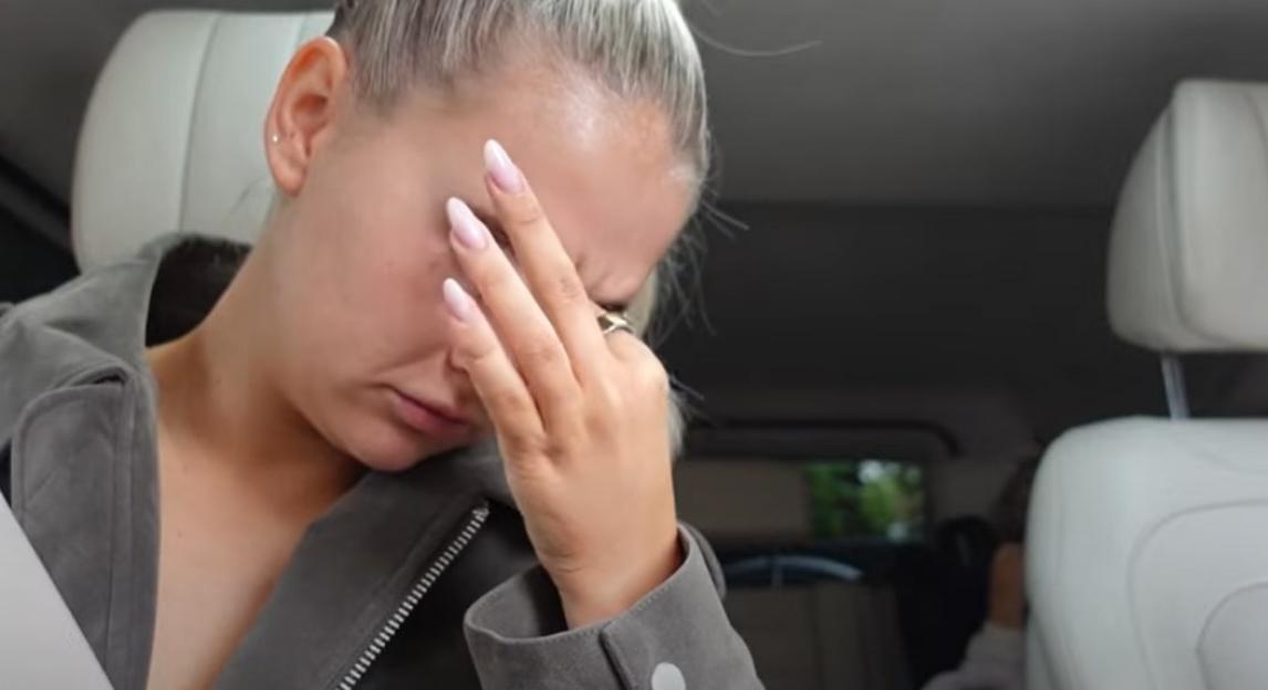 Woman crying in a car.
