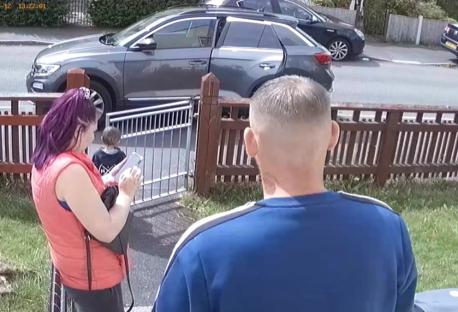 CCTV image of a woman and man in a garden with a young child.