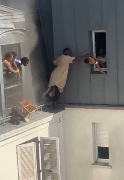 Man catching baby dropped from window.