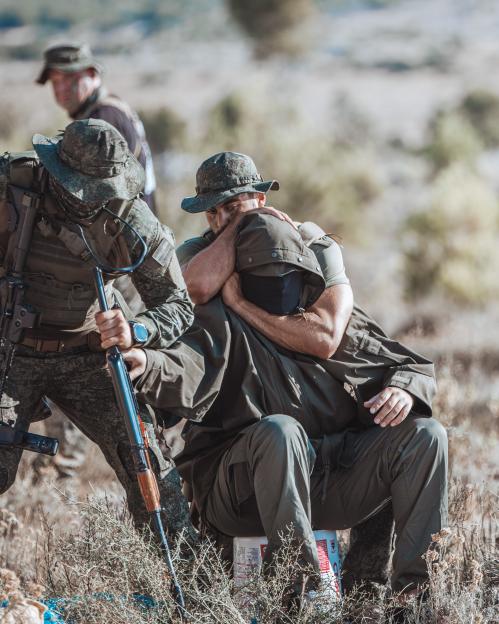 Soldiers apprehending a suspect.