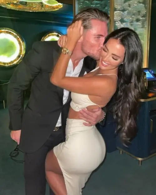 Man kissing woman on cheek.