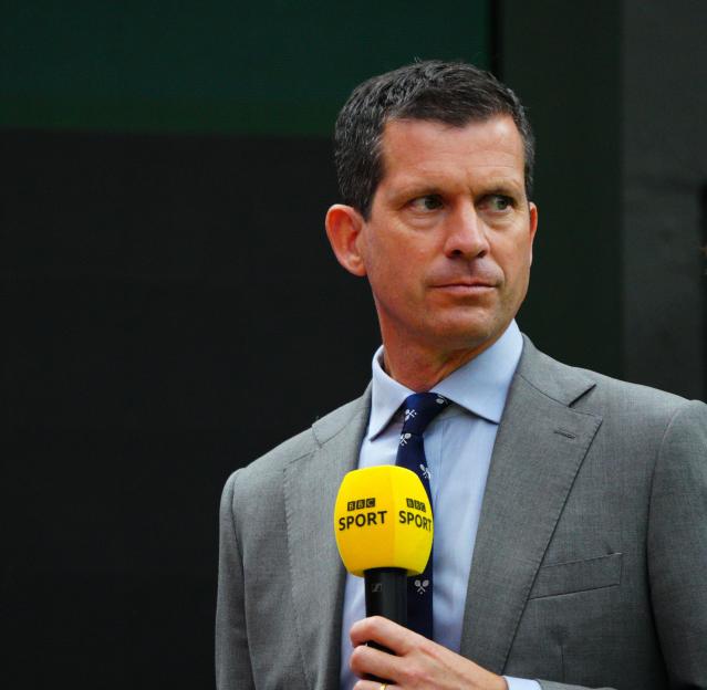 Tim Henman holding a BBC Sport microphone.
