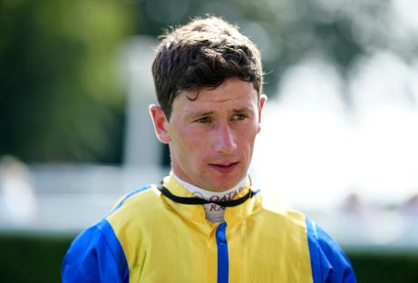 a man wearing a yellow and blue jacket with the word qatar on it