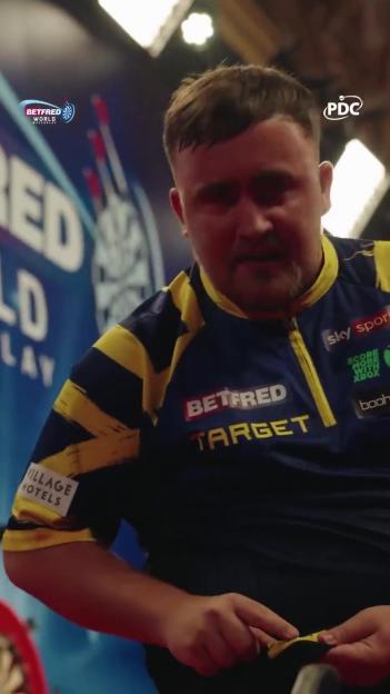 Luke Littler during a darts match celebration.