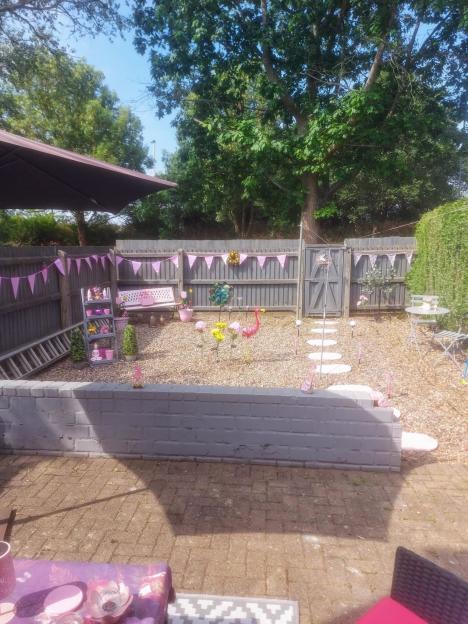 Pink-themed small garden with decorations.