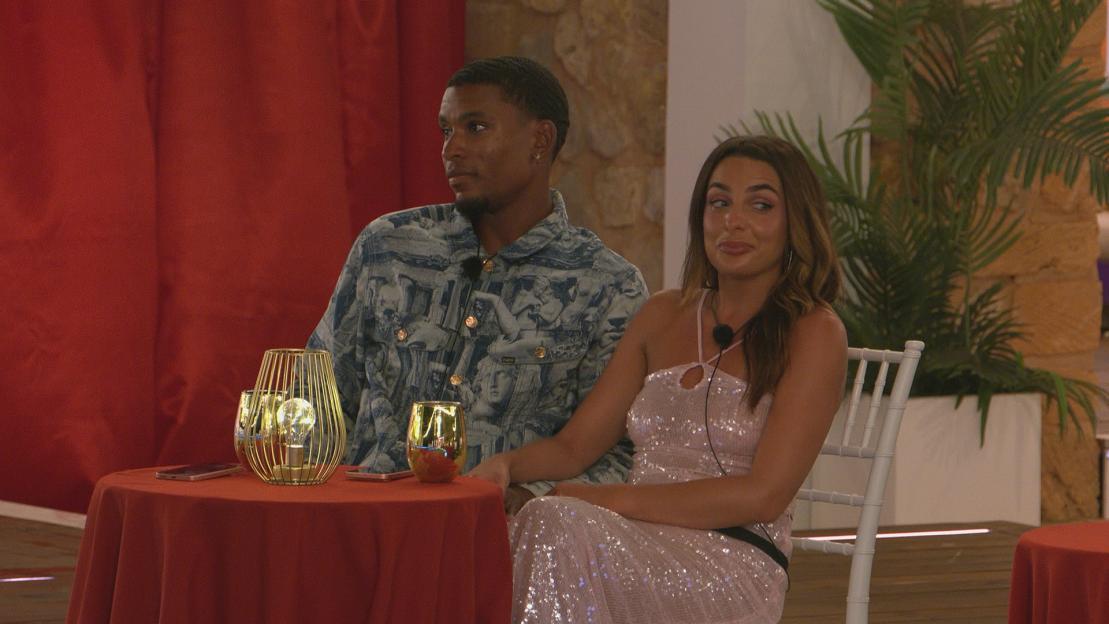Two Love Island contestants sitting together at a table.