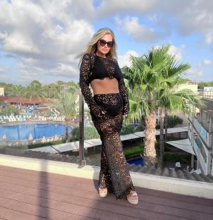 Shaughna Phillips in a black lace two-piece outfit.