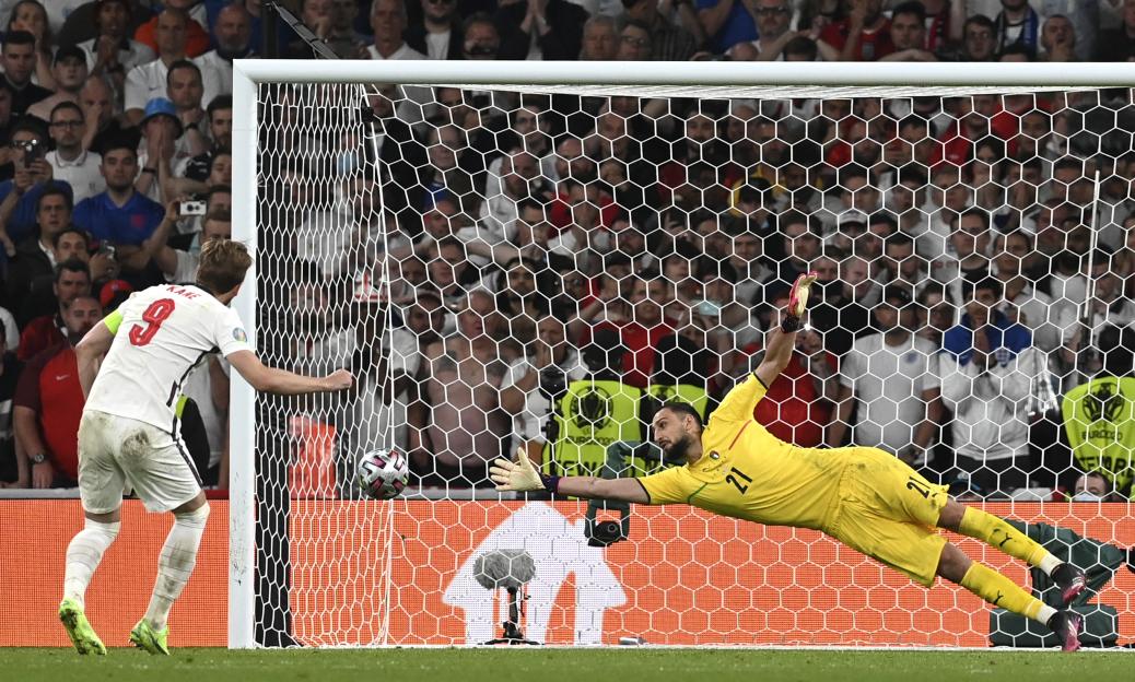 Harry Kane taking a penalty kick during a soccer match.