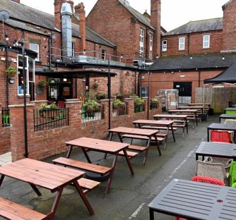 Outdoor patio seating at The Red Lion pub in Bedlington.