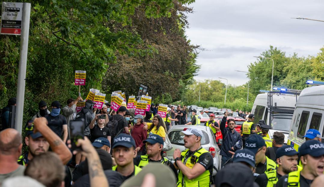 Pro- and anti-immigration protesters clash in Epping, Essex, with police intervening.