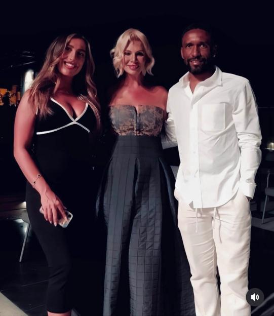 Photo of three people posing together.