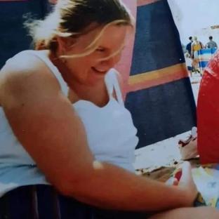 Woman smiling at the beach.