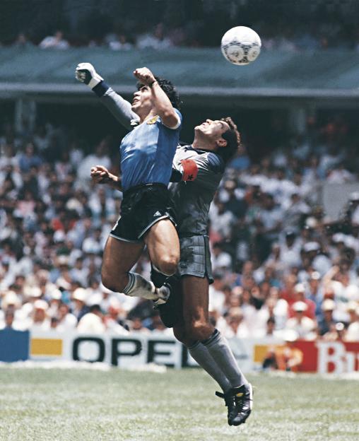 Diego Maradona scoring a goal with his hand during a 1986 World Cup match.