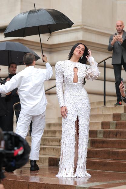 Dua Lipa in a white, feathered gown at Paris Fashion Week.