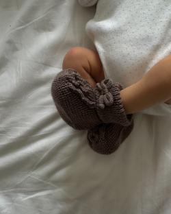 Baby's feet in knitted booties.