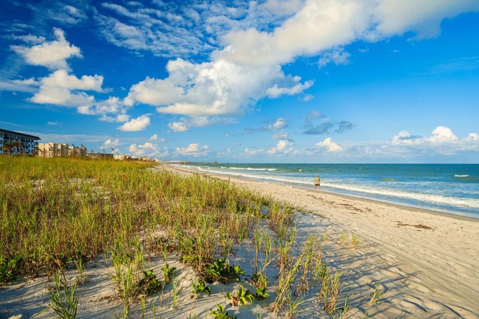 Cocoa Beach, Florida: sandy beach, ocean waves, and blue sky.