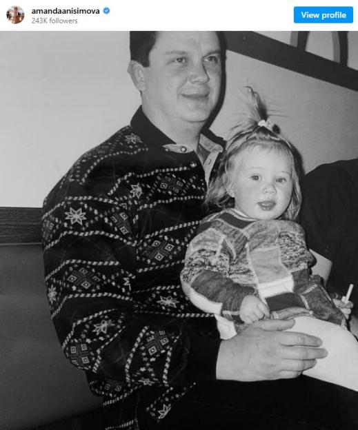 Black and white photo of a Konstantin Anisimov holding his young daughter Amanda Anisimova
