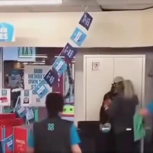 Shop worker apprehending a shoplifter.