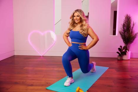Shaughna Phillips in a lunge, promoting her fitness app.