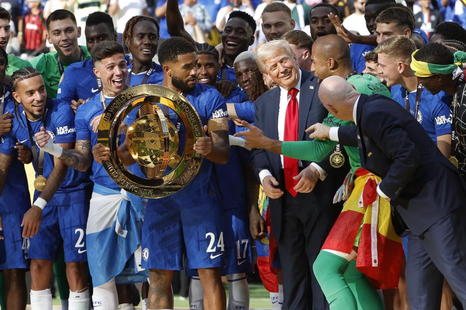 Reece James of Chelsea holding the FIFA Club World Cup trophy with teammates and Donald Trump.