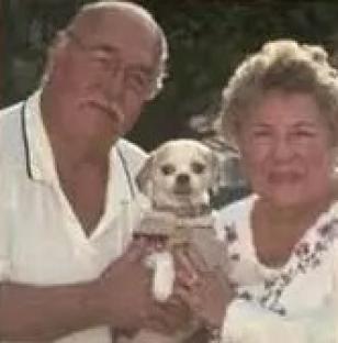 Photo of Stephanie, 73, and Daniel Menard, 79, with their dog.