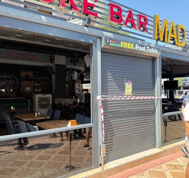 Closed bar with police tape across the entrance.