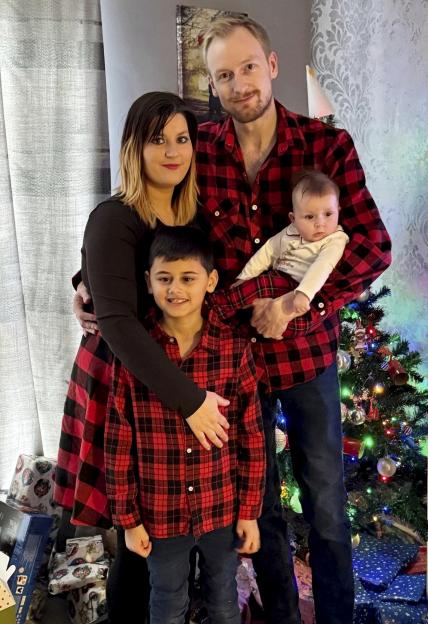 Family portrait in front of a Christmas tree.