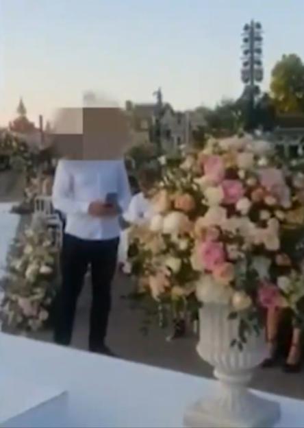 Person looking at their phone at an outdoor wedding.