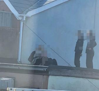 Teenagers on a rooftop.